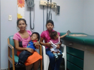 Mrs. Juliana, Sabino and Maria Rosario with her big sister in the  consult room for follow up after her stay in the hospital. She is playing with the toys again!
